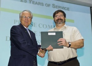 Photo of Ron Wukeson receiving his employee recognition award.