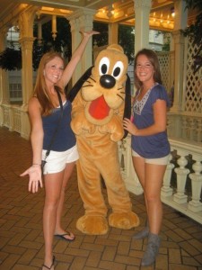 Tiffany Fridley poses with Pluto and another student intern at Walt Disney World.