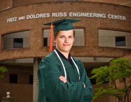 Photo of Kristjan Greenewald in his graduation cap and gown.
