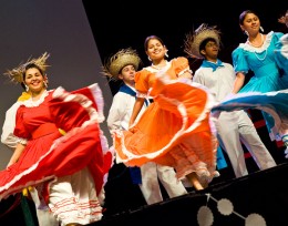 Photo of three female dances in Mexican dresses.
