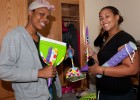 Photo of freshmen Talia Swelo and Natalee Banks showing off some dorm room essentials.