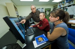 Photo of Ernest Hauser, Ph.D. showing students the benefits of the new geology software.