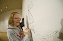 Photo of student drawing her own art at the Stein Galleries