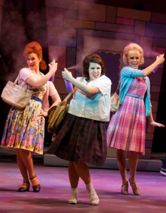 Photo of three actresses spraying cans of hairspray.