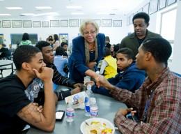 Photo of Dr. McMillan greeting students at Dunbar High School in Dayton, Ohio.