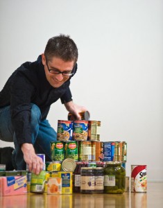 Photo of a man stacking canned food.