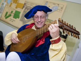 Photo of Jim McCutcheon playing the Lute.