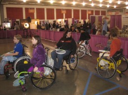 Photo of people usi g wheel chairs in obstacle course