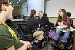 Photo of physicaly disabled Wright State students talking in a classroom.