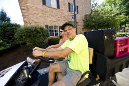 Michael Schulze drives a golf cart at freshman move-in day 2010.