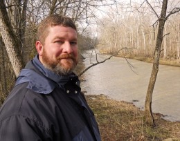 Photo of Tom Mayor by a river
