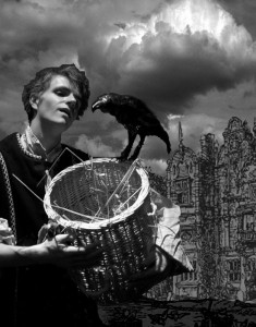 Photo of a boy in medieval clothes with a basket and a crow.