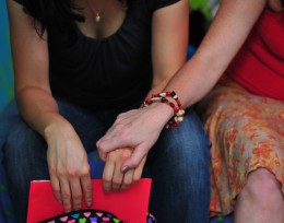 Photo of two women holding hands