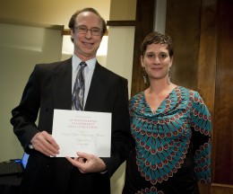 Photo of Bruce Kline, president of the board of directors of the Wright State Alumni Association accepting the Outstanding Nonprofit Organization Award on behalf of the association. At right, graduate student Amanda Turner also won a $250 scholarship.