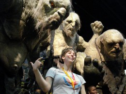 Photo of Lara Donnelly posing for a picture with some life-size monsters at the San Diego Comic Convention.