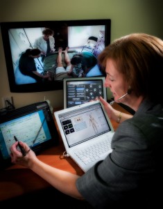 Photo of someone controling patient simulators. 