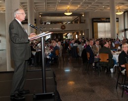 President Hopkins speaking at a podium.