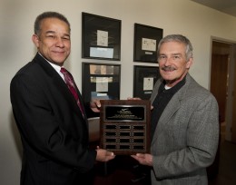 Photo of Larry James, Ph.D., dean of the School of Professional Psychology (left); and Jerry Yung, husband of the late Betty Yung, an associate professor at SOPP, display a plaque marking The Dr.Betty Yung Awards.