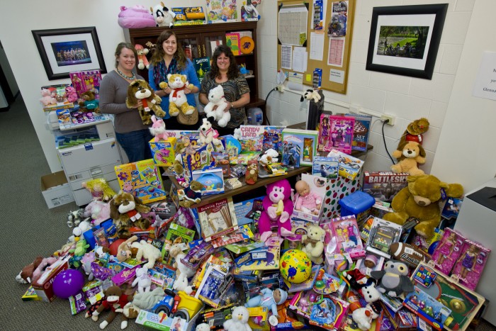 (L-R) Jenna Rigg, Jaclyn Stapleton and Annette McCoy display Wright State's 2013 donation of unwrapped toys for the FLOC Toy Cottage in Montgomery County.