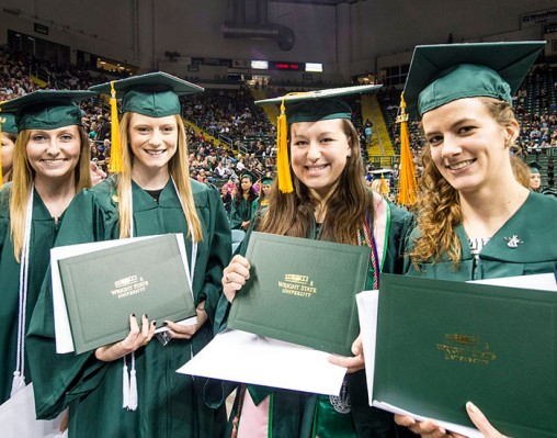 Graduates with diplomas