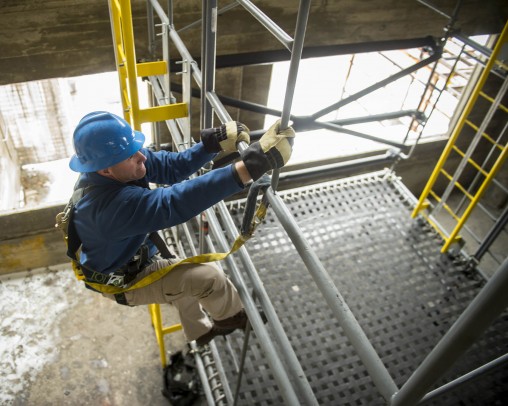 Worker climbing scaffolding