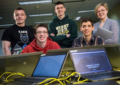 computer science and computer engineering students with laptops