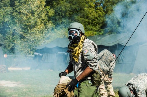 Soldier with gas mask in field