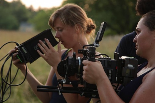 Writer/director Aubrey Keith looks at the framing of a scene in her film "Oak" while cinematographer Haley Shepard adjusts the camera.