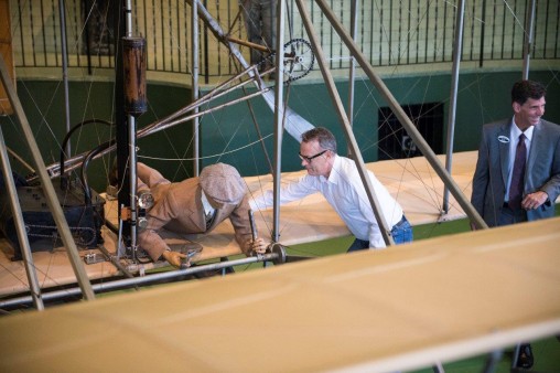 Tom Hanks with the 1905 Wright Flyer III at Carillon Historical Park. At right is Brady Kress '96, the park's president and CEO. (Photo by Will Jones)
