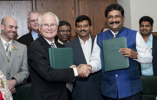 Wright State President David R. Hopkins and Ganta Srinivasa Rao, the minister for human resources development of Andhra Pradesh, shake hands after signing a memorandum of understanding.