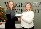 Amanda Herbe is presenting a check to Helen Williams, a board member of Greene County Children Services.