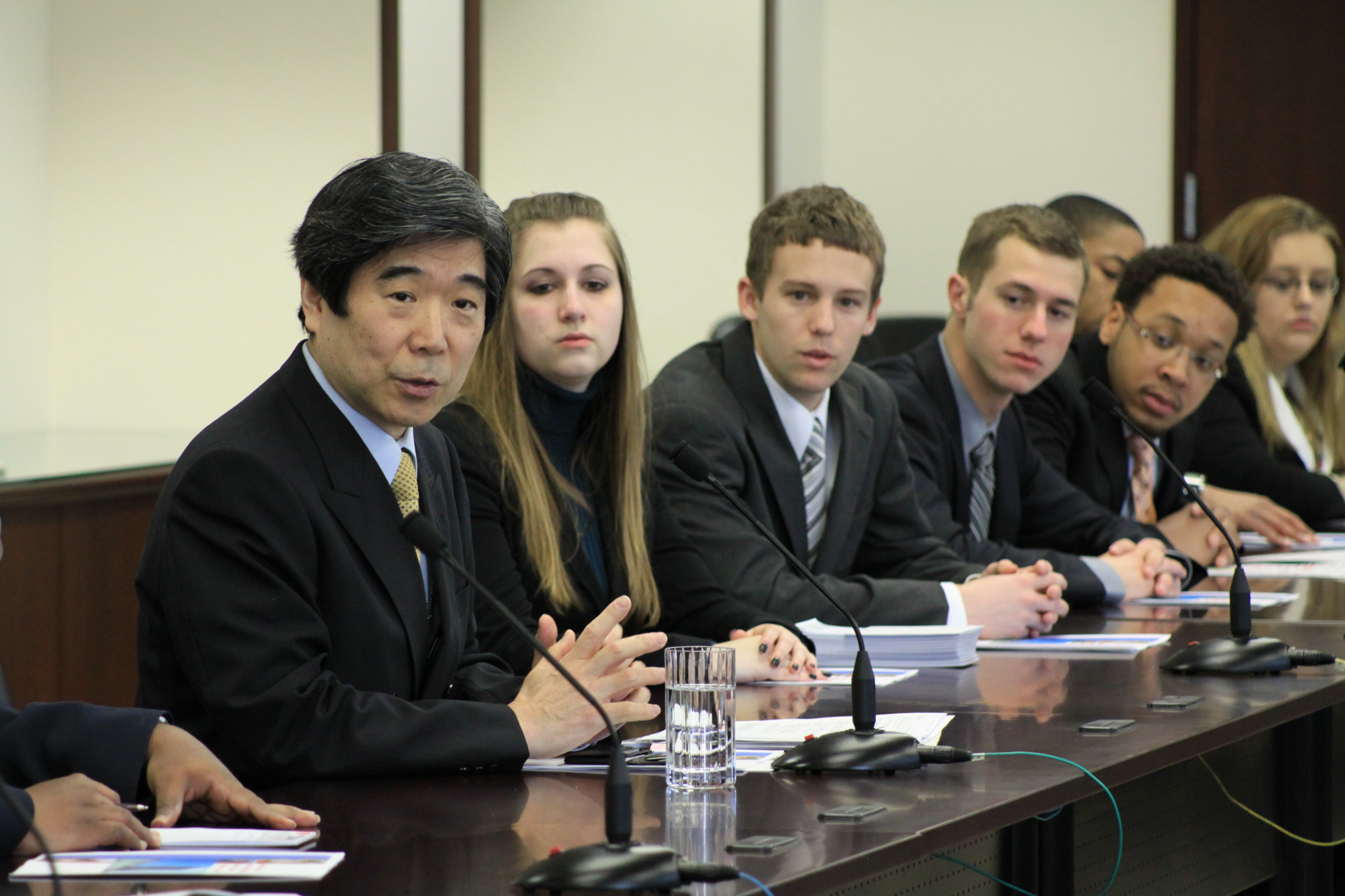 Wright State students from Model UN team sitting next to Japnese Ambasador for question and answer session