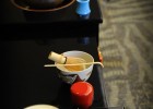 Photo of china cups and a teapot on a low table.