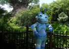 A Bug's Life movie character poses for a picture along a fence at Walt Disney World.