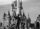 Picture of Walt Disney and Mickey Mouse statues in front of Cinderella's Castle at Disney World.