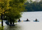Photo of three people in kayaks on Eastwood lake during Wright State University's Introduction to Kayaking class.