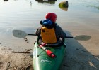 Photo of a student waiting his turn launch off the beach and into Eastwood Lake during Wright State University's Introduction to Kayaking class.
