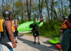 Photo of instructor and students carrying their kayaks.
