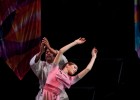 Photo of John Wesley Wright in prayer position and a dancer in pink dancing.