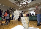 Photo of a view of opening reception for the 2011 Senior Show, sculpture of rock and metal by Bret Eikenbery.