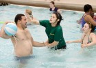 Photo of a Wright State student playing with his sisters in the Wright State pool during Sibs Weekend.