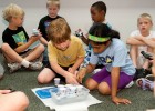 Photo of children building a boat and filling it with pennies to see how heavy it could get without sinking.