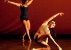 Photo of two dancers in tank tops and biker shorts.