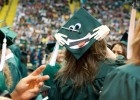 Photo of one student's specially decorated mortar board with a smily face.
