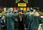 Photo of Wright State University President David R. Hopkins shaking hands with graduates at commencement.