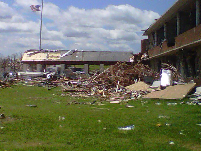 Photo of a school destroyed by the tornado, though the flag pole still stands.