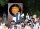 Photo of Dr. Cambronero speaking to a group of children in front of the sculpture of Jupiter.