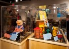 Photo of a display case with toys including a puppet.