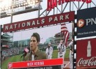 Photo of JumboTron at Washington National baseball game showing Wright State grad Nick Verina signing the national anthem.