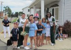 Photo of the Wright State Spirit Team posing with kids along the parade route.
